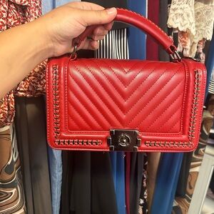 Red medium flap closure bag with metal details quilting
